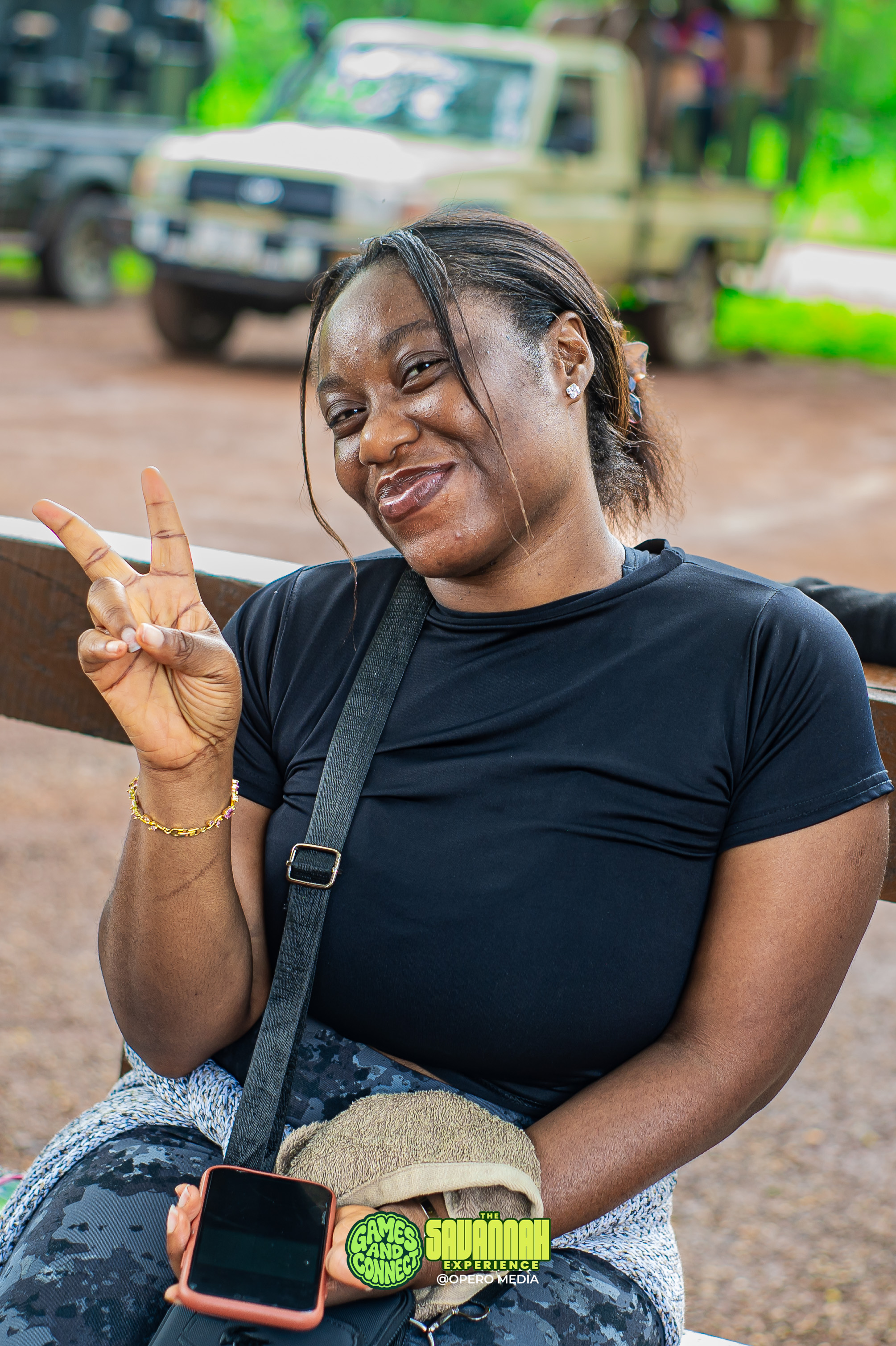A Games and Connect member smiling and making a peace sign at the Savannah Experience